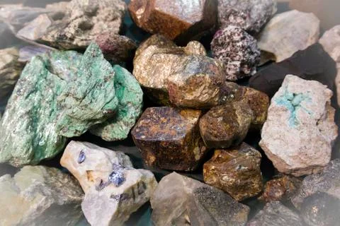 Large piece of raw malachite between other stone fragments Stock Photos