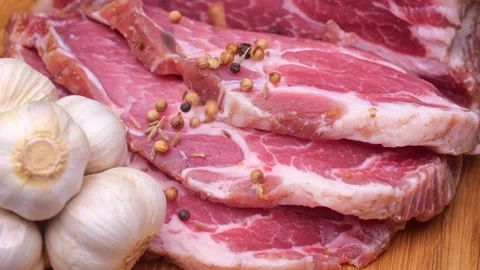 Large piece of raw meat sprinkled with spices Stock Footage 228080642