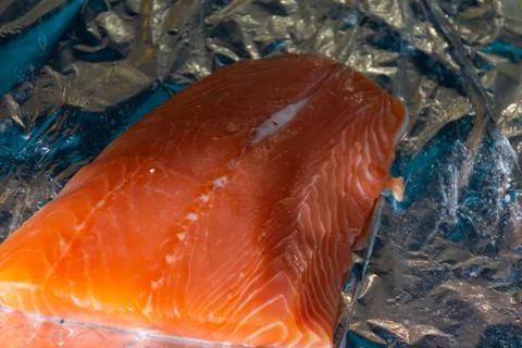 Large piece of trout on a baking sheet on foil Stock Photos