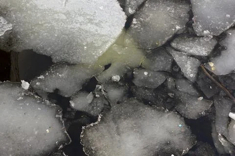 Large pieces of melted ice float in the river Stock Photos