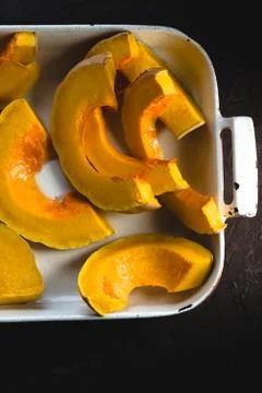 Large pieces of pumpkin in the form for baking close-up Stock Photos