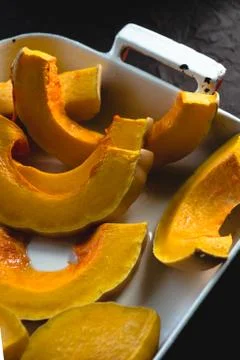 Large pieces of pumpkin in the form for baking diagonal close-up Stock Photos