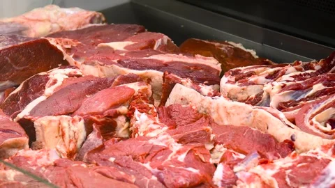 Large pieces of raw meat lying on the counter. Stock Footage 328223120