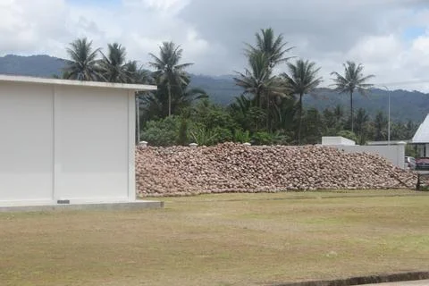 Large pile of coconuts outside processing facility in tropical Indonesia Stock Photos