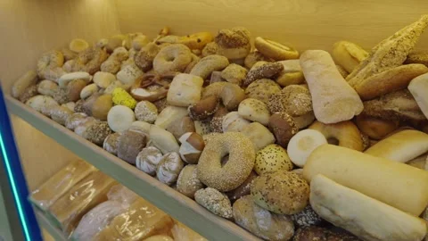 Large pile of fresh bread on a shelf. Bakery assortment. Stock Footage 304316927