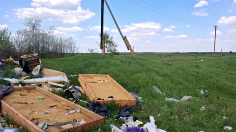 A large pile of garbage in the grass outside the city.Human pollution. Stock Footage 335077689