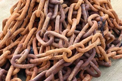 Large pile of large old rusty orange brown nautical chain Stock Photos