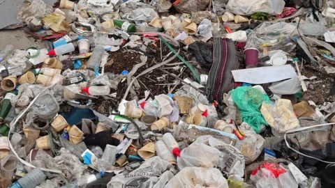 Large Pile of Mixed Garbage and Plastic Waste Dumped Outdoors - Environmental Stock Footage 336364073