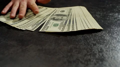 A large pile of money is lying on the table, which is being stretched. Stock Footage 265253101