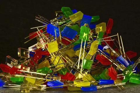 A large pile of multi-colored low-power LEDs in a rectangular plastic case Stock Photos