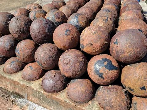 Large pile or stack of rusty iron cannon balls Stock Photos
