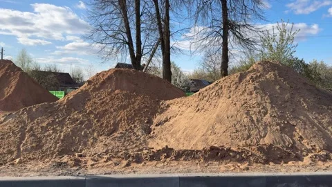A large pile of sand at a construction site for a city road Stock Footage 334067136