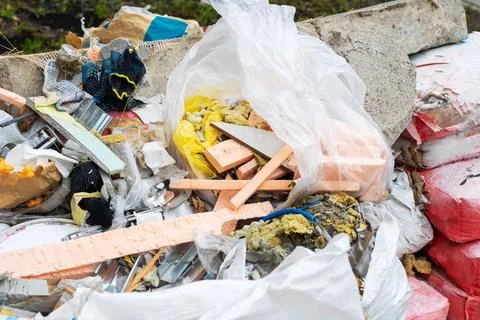 A large pile of trash featuring a plastic bag stuffed full of foam Stock Photos