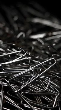 A large pile of triangular shaped shiny silver paper clips 写真素材