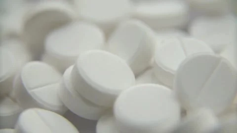 Large pile of white round pharmaceutical pills and tablets Video stock 333876055