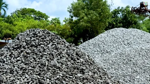 Large piles of gray and white gravel stones under a clear blue sky with lus.. Stock Footage 339295830