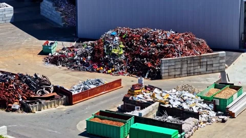 Large piles of sorted metal waste in a junk yard ready for recycling and Stock Footage 346580202