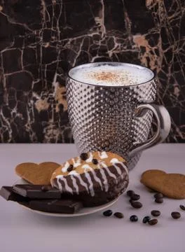 Large pimpled silver cup of coffee and cakes bisquits chocolate and coffee be Stock Photos