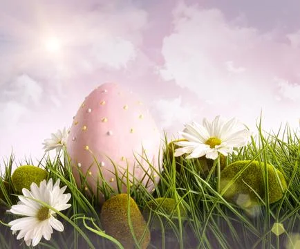 Large pink easter with flowers in tall grass Stock Photos