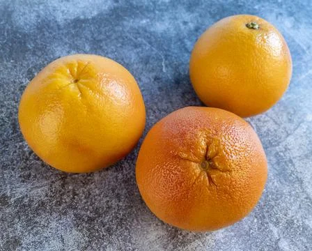 Large pink grapefruits on a table Stock Photos
