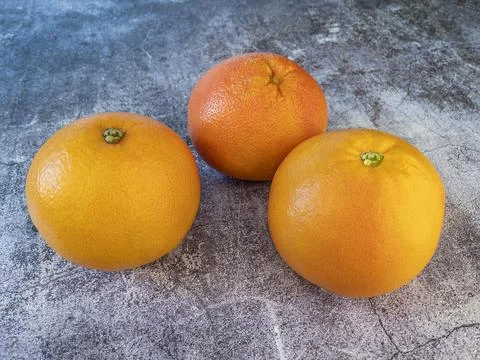 Large pink grapefruits on a table Stock Photos