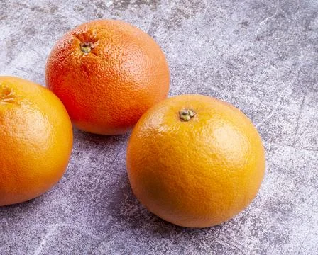 Large pink grapefruits on a table Stock Photos