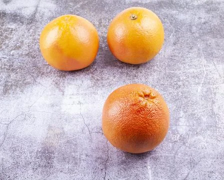 Large pink grapefruits on a table Stock Photos