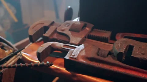 Large pipe wrenches on a workbench. Zoom to close up. Stock Footage 315215780