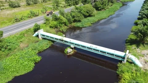 Large pipes supplying clean water that cross the river Video stock 321845254