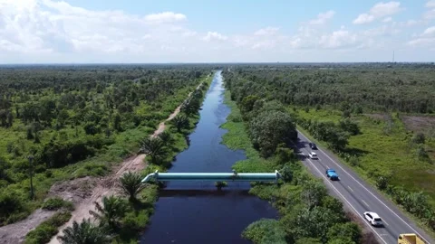 Large pipes supplying clean water that cross the river Stock Footage 321845295