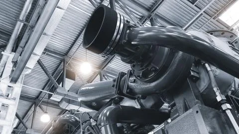 Large  piston gas engine electric generator with many valves and pipes. The e Stock Photos