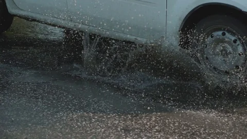 A large pit on the road, filled with a puddle. Stock Footage 116564988