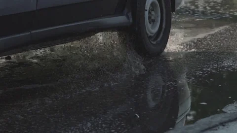 A large pit on the road, filled with a puddle. Stock Footage 116565024