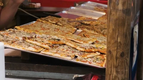 Large pizza divided into portions Stock Footage 220150590