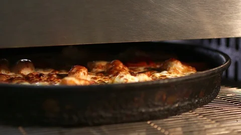Large pizza goes from the oven. Video stock 87636865