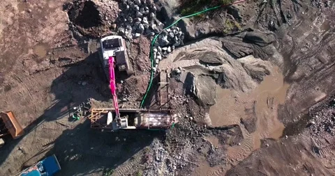Large placer mining operation in remote Yukon land with pink excavator Stock Footage 139689383
