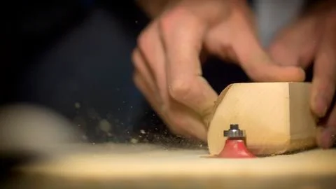 A large plan, hands of an artisan working on a wooden part Stock Photos