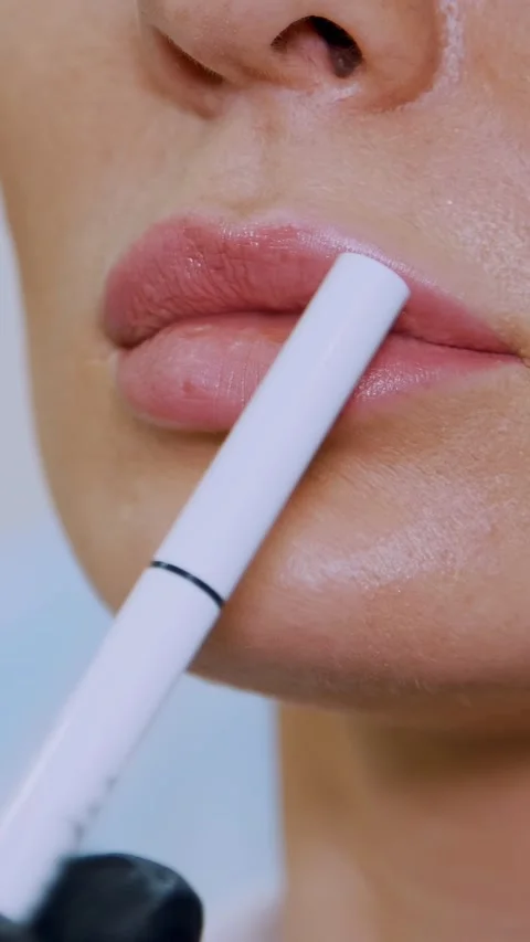 A large plan of the lips, the doctor shows the patient a lip zone for injection Stock Footage 305936052