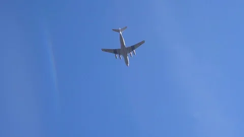 Large plane in the blue sky over Moscow slow motion video Stock Footage 89970478