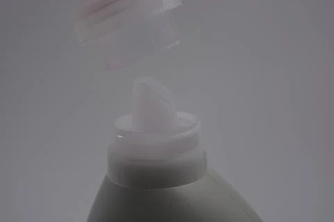 A large plastic bottle with purple cleaning liquid, a clear plastic cap. Stock Photos