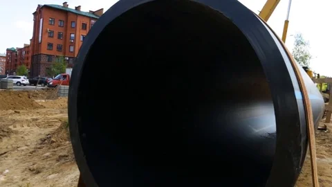 Large plastic sewer pipe with a blue stripe on the side of PEX wrapped in webbin Stock Footage 81917008