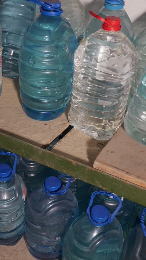 Large Plastic Water Bottles Stored for Emergency Supply on Shelves Stockbeeldmateriaal 335646961