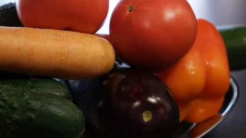Large plate with fresh vegetables. ginger, carrots, tomatoes, eggplant, avocado Stock Footage 122412207