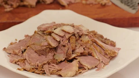 A large plate piled high with braised beef slices. Stock Footage 343327778