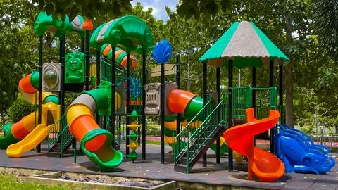 A large play complex for children in a green recreation area 스톡 사진