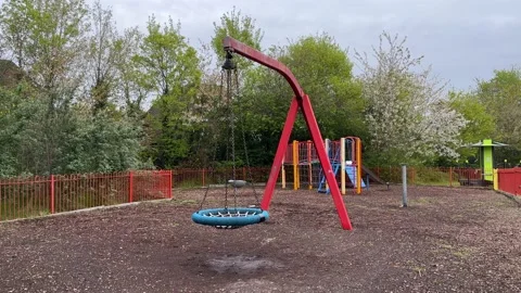 Large playground in England - Large Swing Stock Footage 239629451