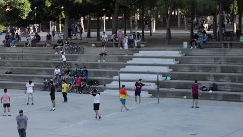 A large playground where there are people enjoying playing football together Stock Footage 133173105