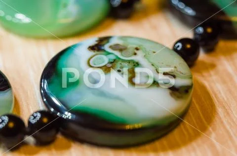 Large polished beads of beautiful translucent green agate gemstone, macro Stock Photos