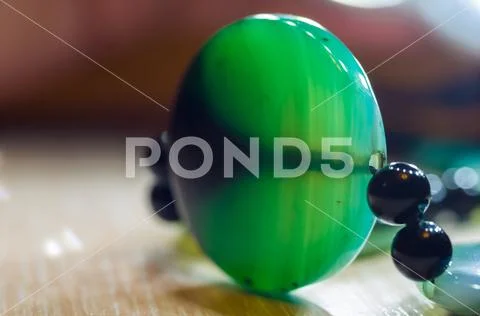 Large polished beads of beautiful translucent green agate gemstone, macro Stock Photos