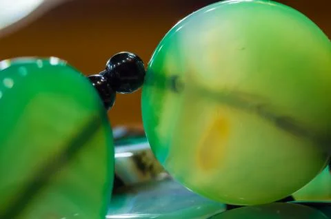 Large polished beads of beautiful translucent green agate gemstone, macro Stock Photos
